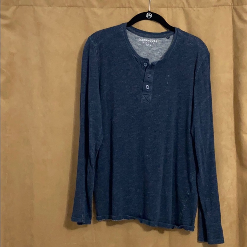 Long sleeved shirt with a few buttons.
